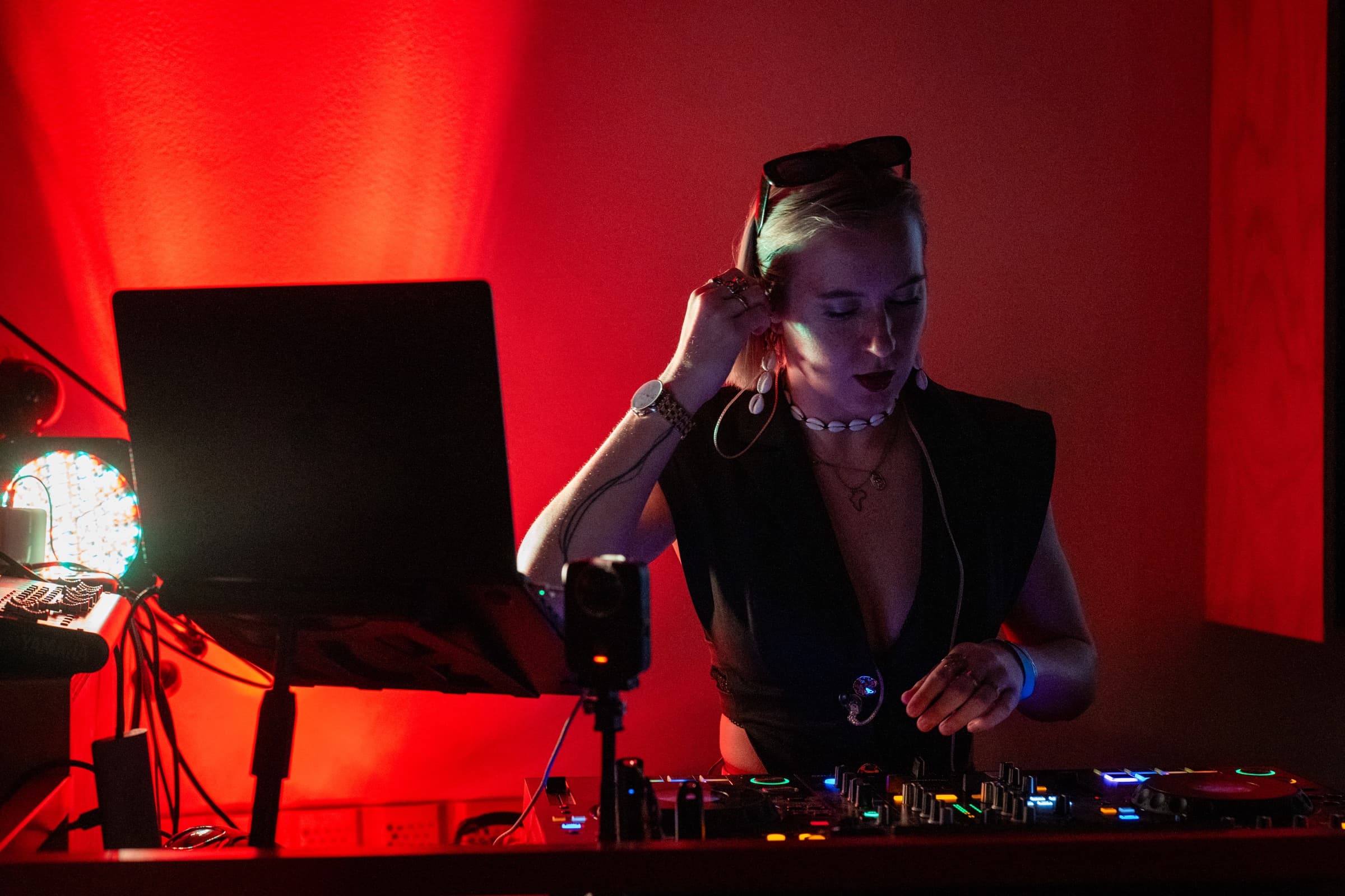 DJ performing under dramatic red light