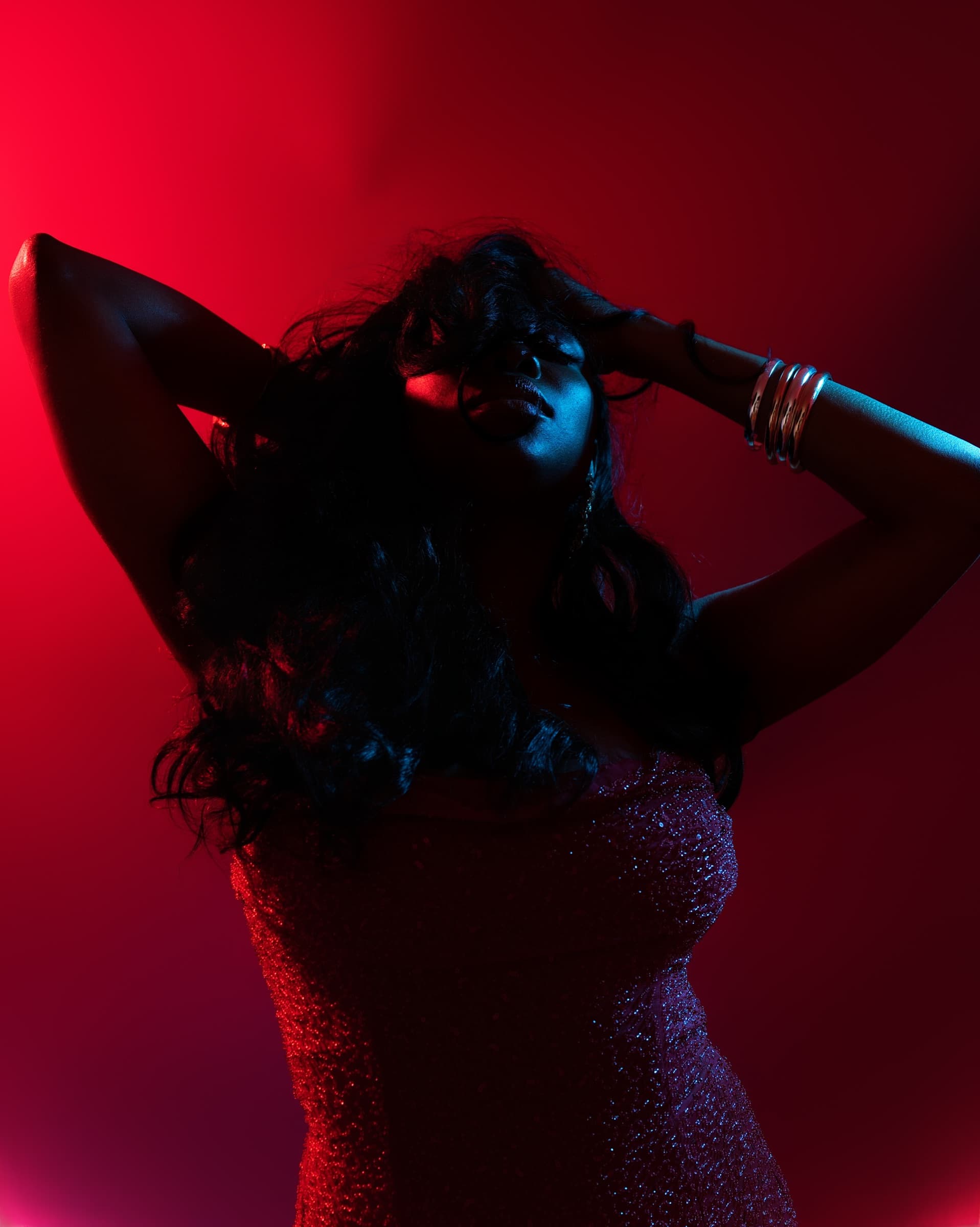 Artistic studio portrait bathed in deep red light